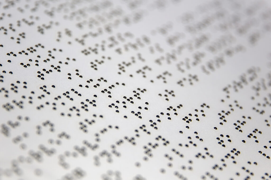 Braille alphabet on the white paper